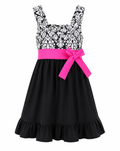 A sleeveless black and white damask-patterned dress with a bright pink waistband and bow, shown on a plain white background.