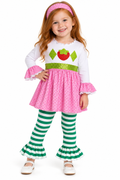A young girl modeling a strawberry-themed costume dress with a white long-sleeve top, pink polka-dot skirt, green sequin waistband, green-and-white striped tights, and a pink headband on a white background.
