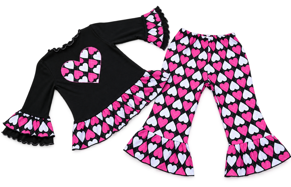 Girls Valentine's Day outfit with black ruffle top, heart applique, and pink and white heart print bell bottom pants